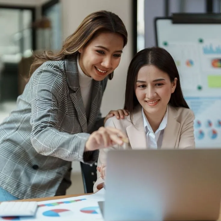 Two colleagues going through an analytics dashboard together